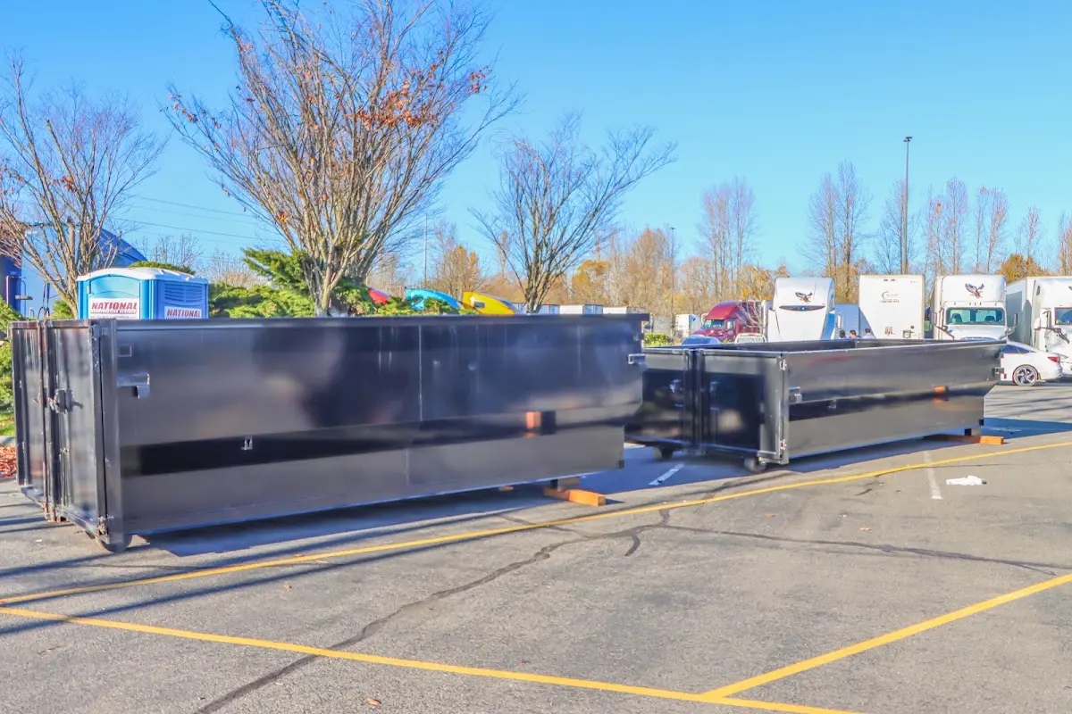 Professional dumpster rental service with roll-off container on residential driveway in Greendale